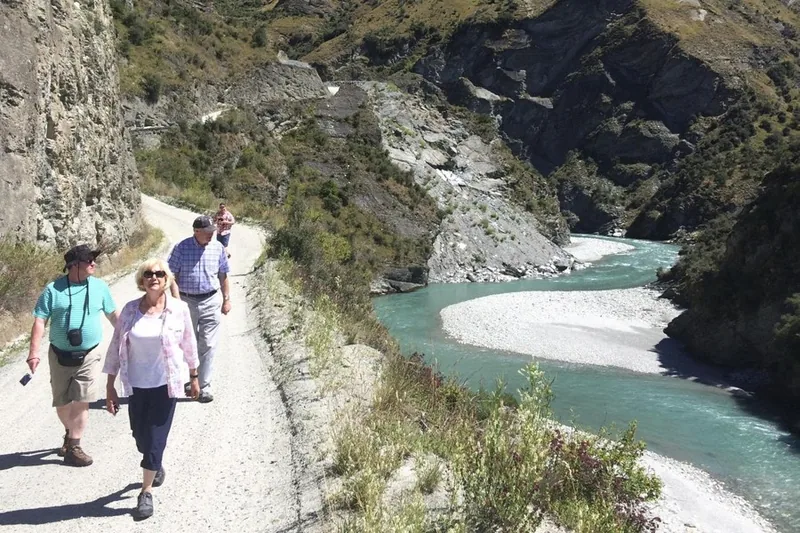 Visitors in jackets on a track above the Shotover gorge